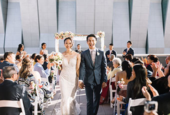 couple walking down the aisle at the camera